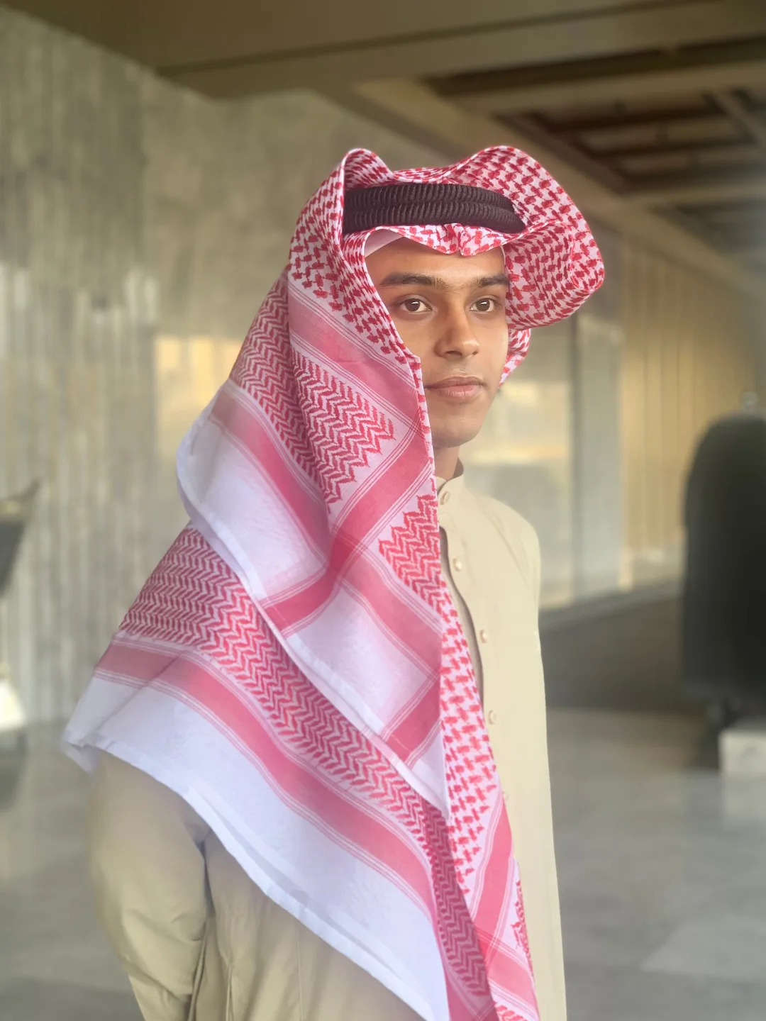 Rafsan Jani Rupok in a white thobe and red checkered keffiyeh